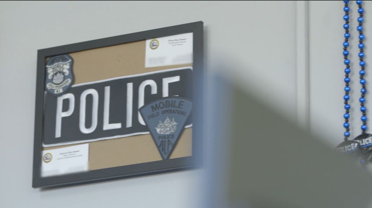 Mobile police patches on a wall in The First 48